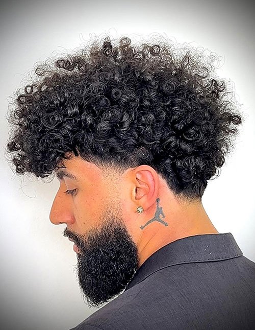 Curly blowout taper fade haircut with beard