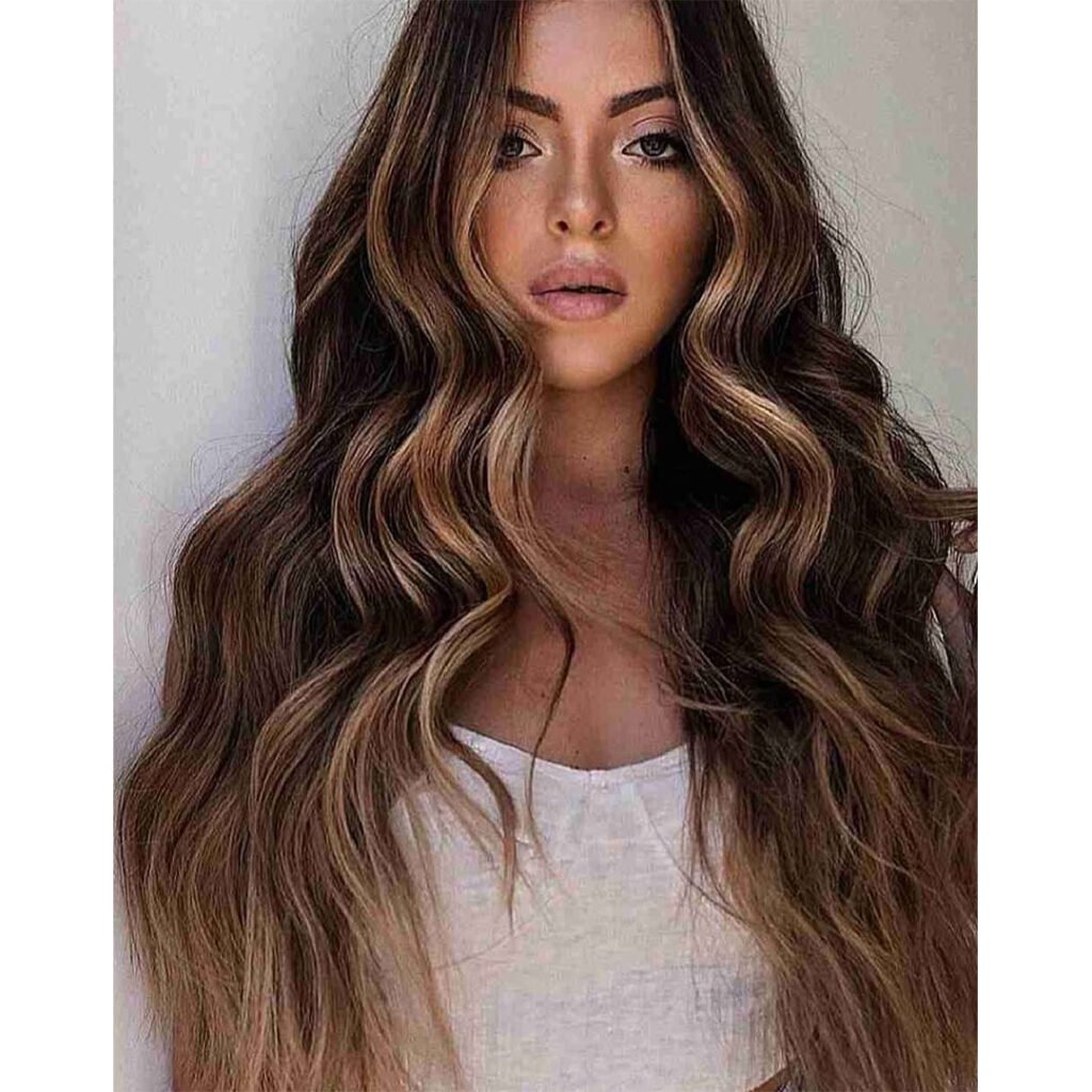 Soft ribbons of caramel weave through dark strands like golden hour sunlight filtering through leaves &mdash; warm, radiant, and timeless.