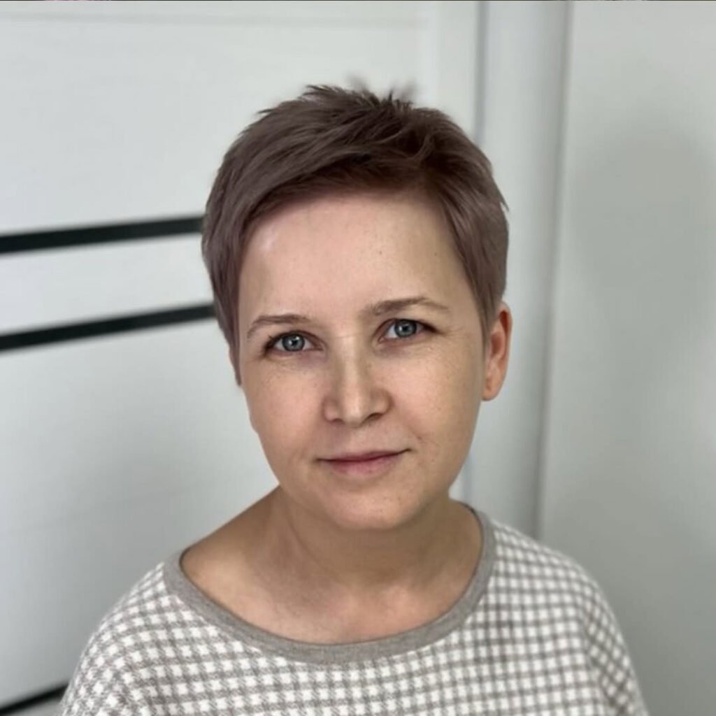 Sweet but smart, this cocoa-toned pixie with its micro fringe feels like a Parisian caf&eacute; &mdash; polished, poetic, and quietly bold.

