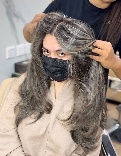 Voluminous salt and pepper layered blowout with soft body and shine