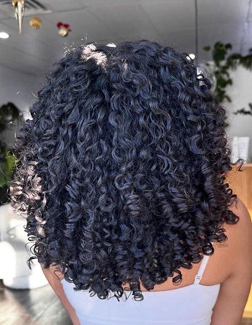 Curly chin-length layered bob haircut