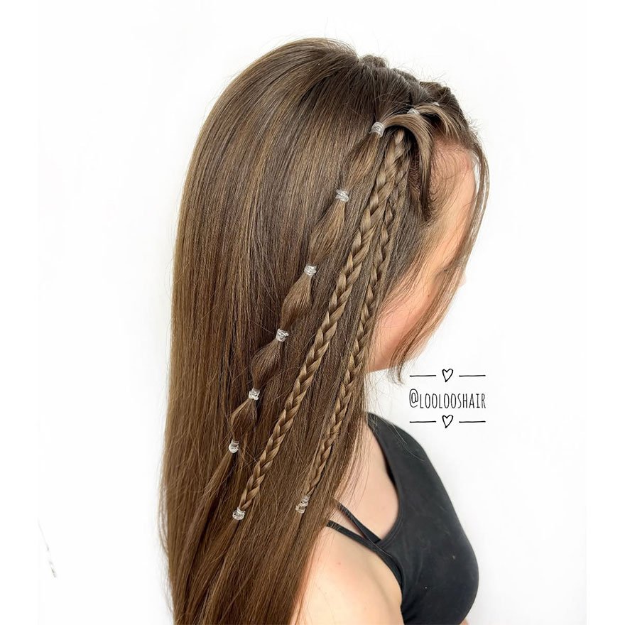 Woman with sleek ponytail featuring accent bubble and mini braids.