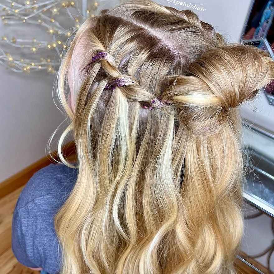 Half-up twist bun with loose waves hairstyle