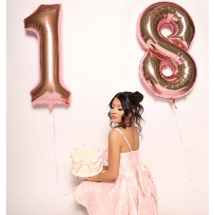 Half-up half-down curls with a small top bun, perfect for birthdays or sweet 18 looks.