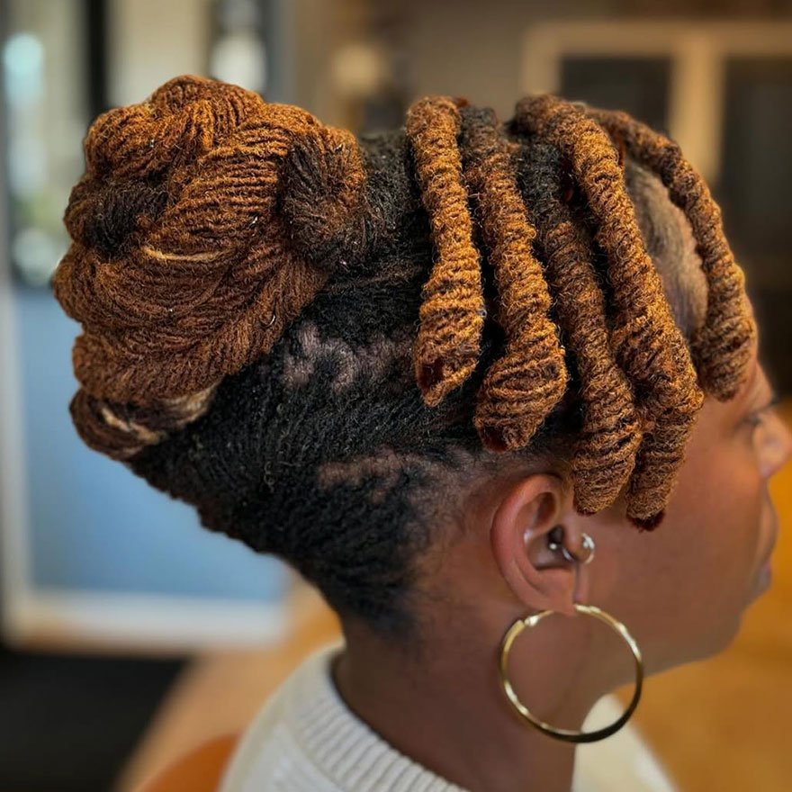 High bun sisterlocks hairstyle on Black woman