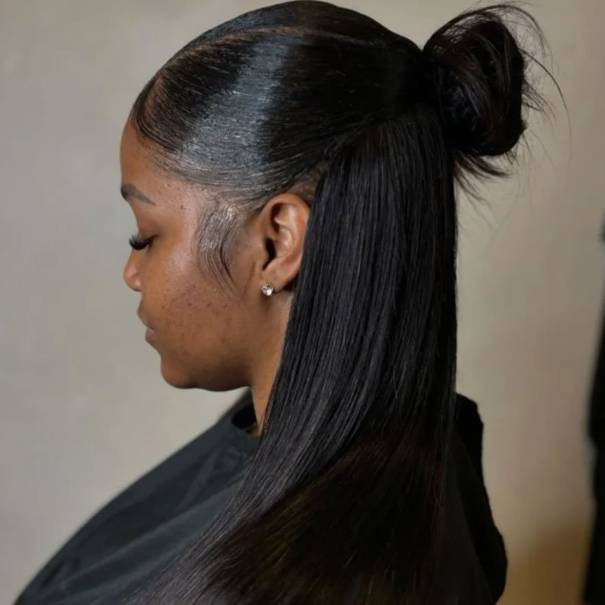 Sleek half-up bun hairstyle with straight black hair