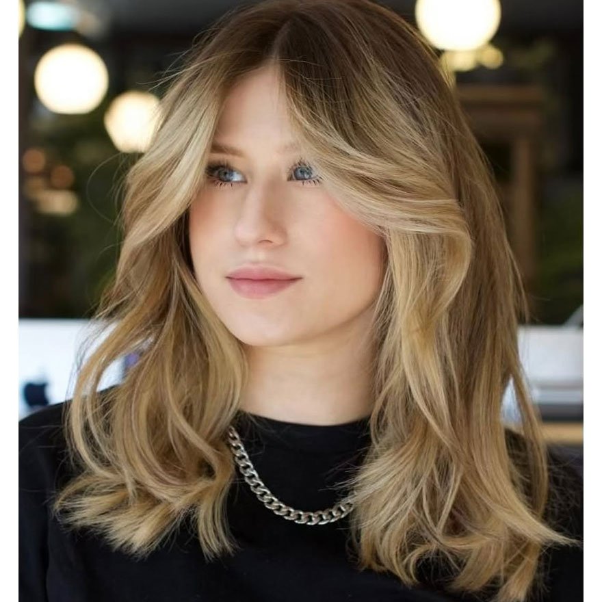 Soft layered lob haircut with curtain bangs