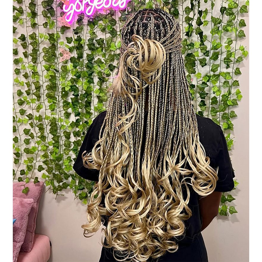 Long French curl braids cascading down the back with soft wavy ends.