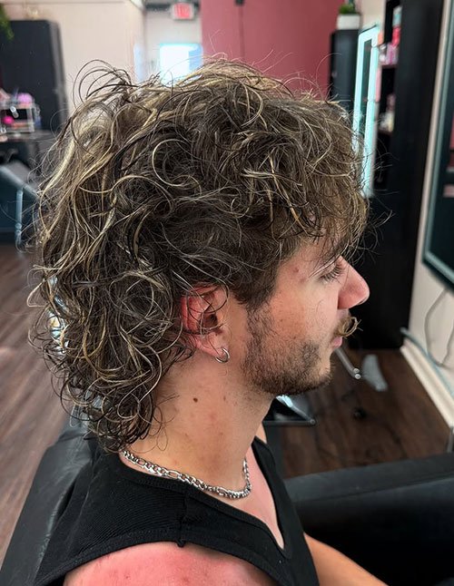 Soft blonde highlights on textured men’s haircut