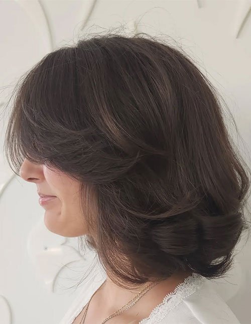 Soft feathered butterfly bob haircut with layers
