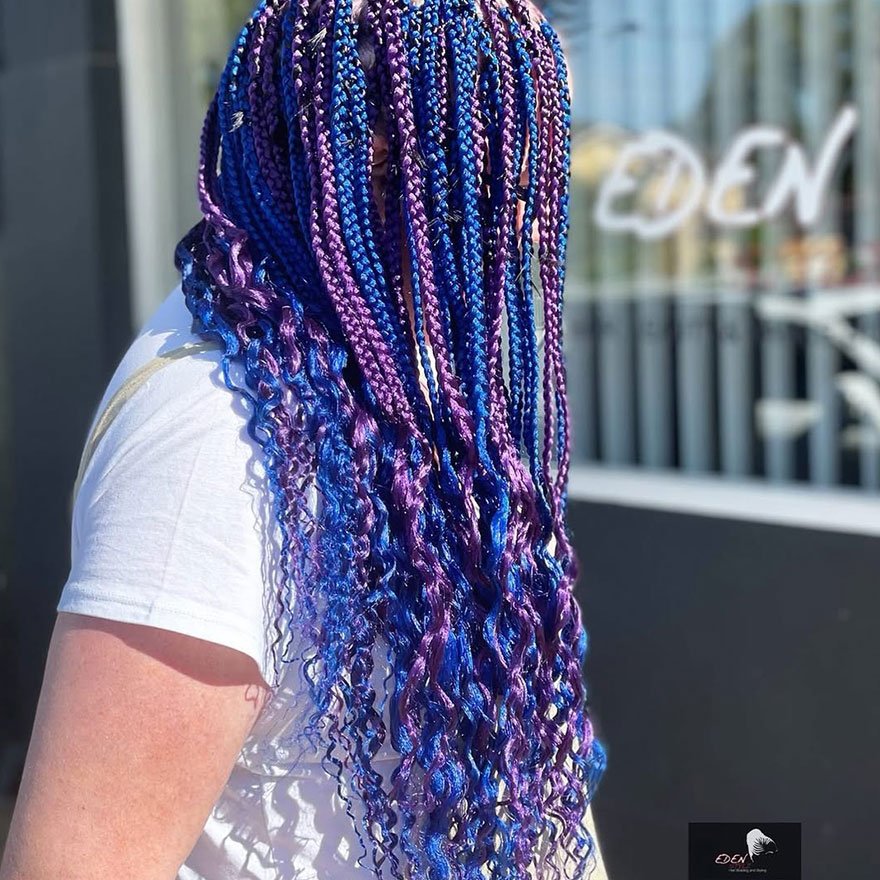 Blue and purple box braids hairstyle with long extensions.