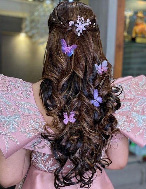 Butterfly embellished half-up soft curls with loose bridal waves