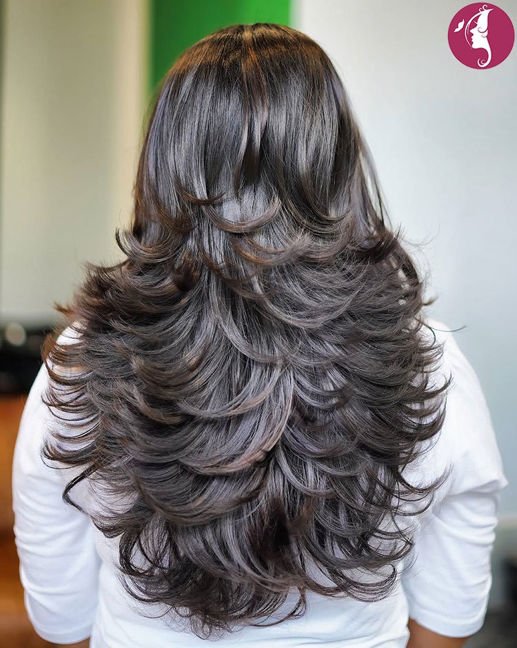 Floating butterfly layers haircut with soft volume and feathered ends