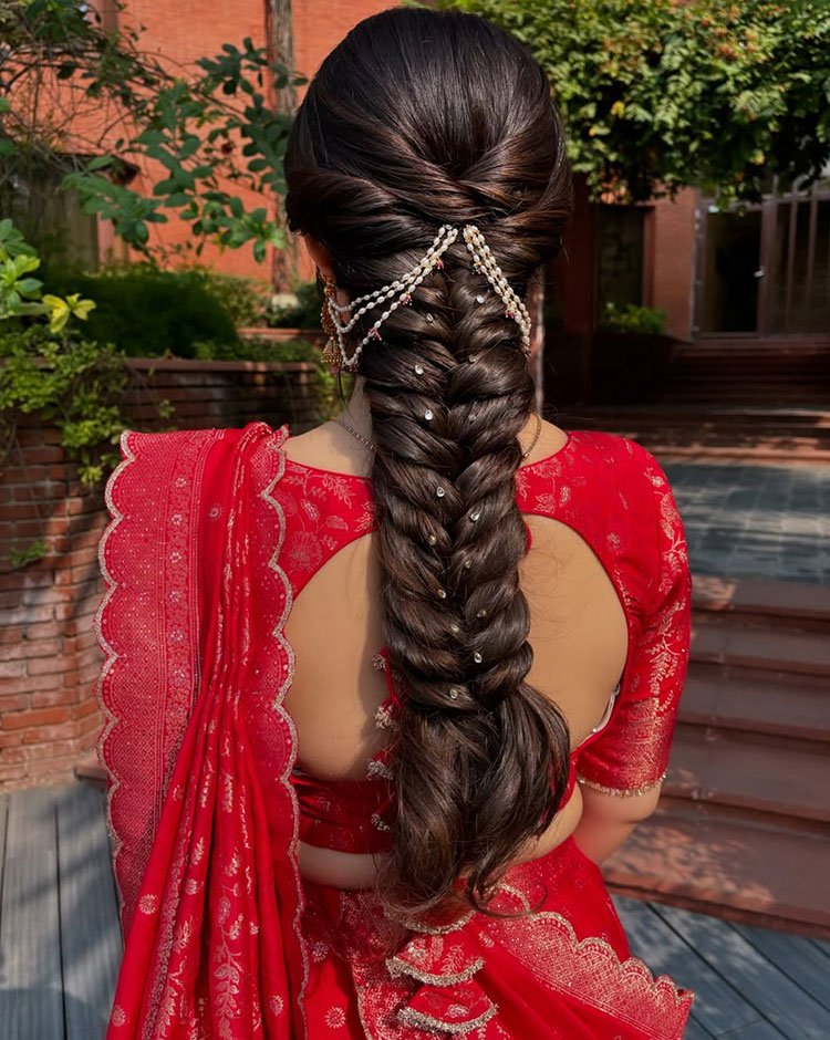 Braided hairstyle with added hair accessory, featuring a long braid from the crown.