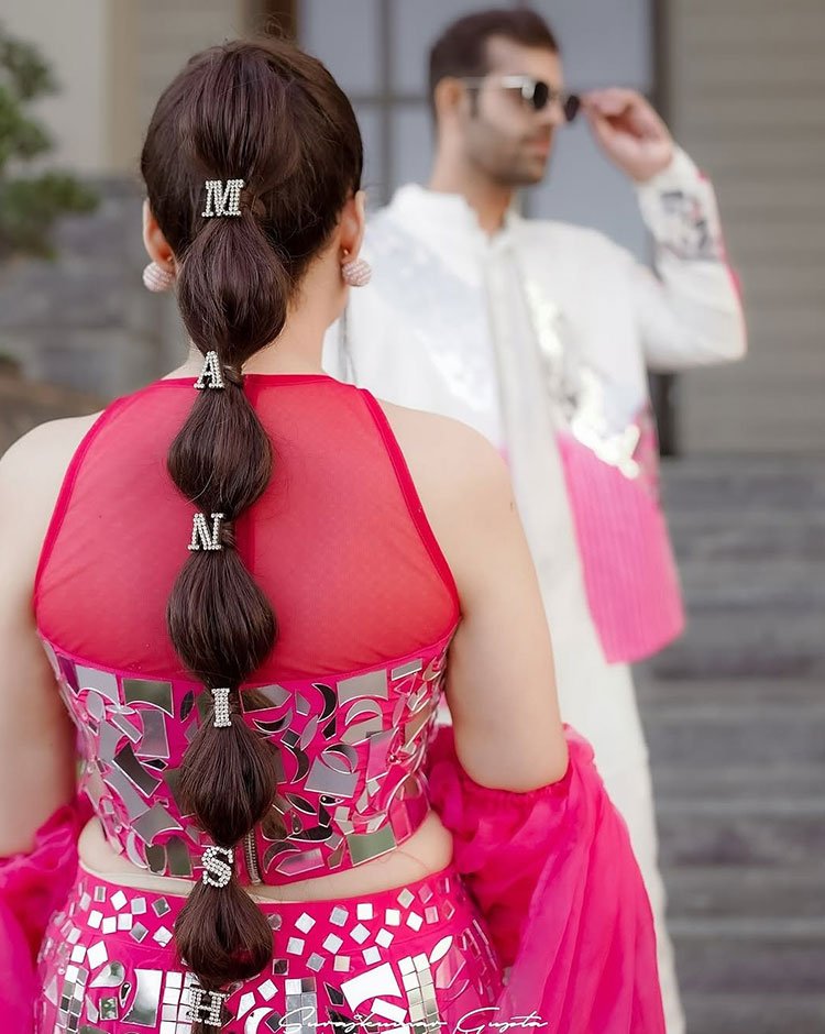 Bubble braid hairstyle with hair accessories from the back.