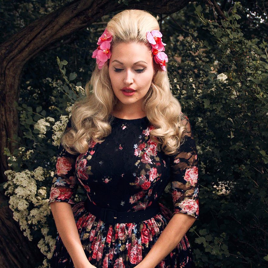 Vintage floral pin-up hairstyle with soft curls.