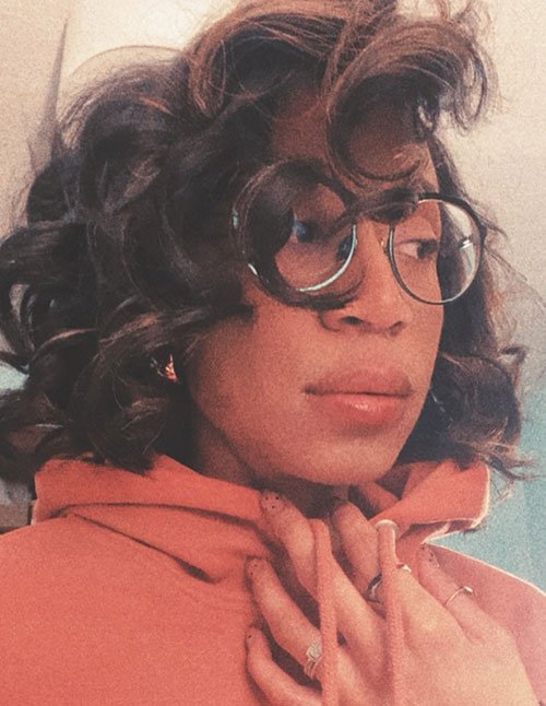 Fluffy curly hair with soft bangs and natural volume
