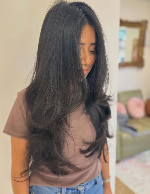 Long layered haircut for thin hair with soft volume and natural flow