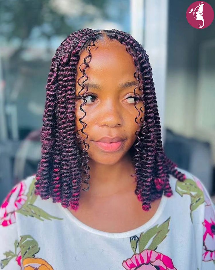 Medium box braids styled with curly ends, front-facing hairstyle