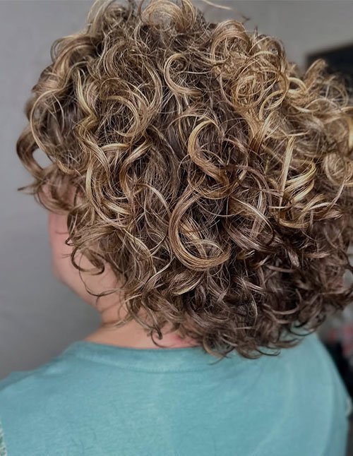 Short curly bob hairstyle for women with defined curls and natural volume