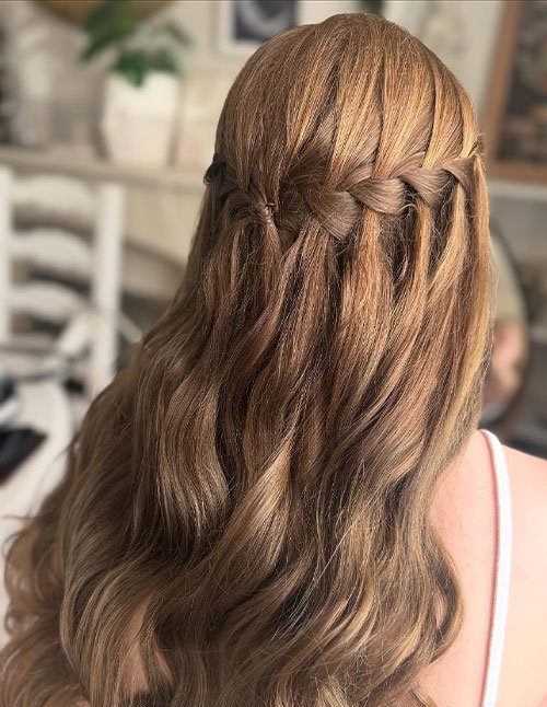Wedding waterfall braid hairstyle with loose curls from back view