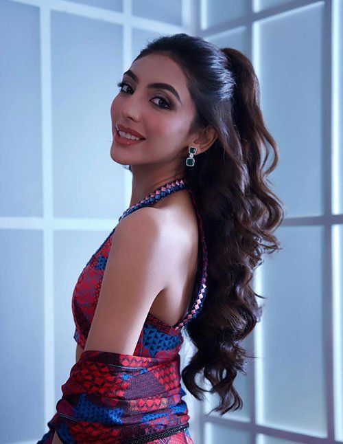 Sleek half-up ponytail with loose curls party hairstyle