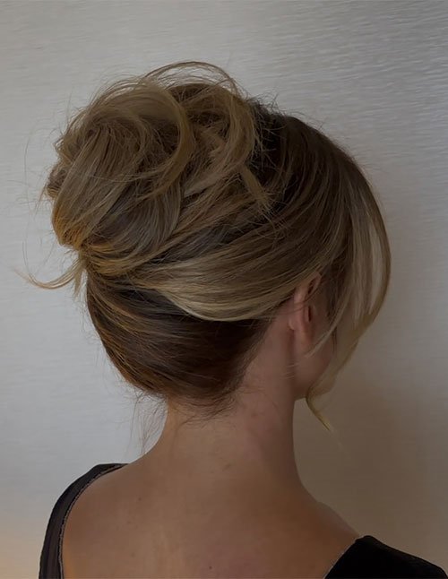 Textured loose low bun updo for medium hair