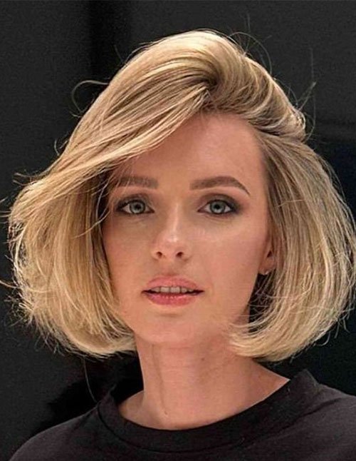 Bob Haircut with Side Part featuring a chin-length blonde bob with side-swept volume