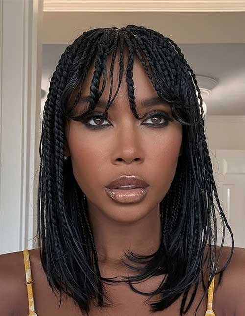 Boho cornrow braids with neat scalp braiding and loose, wispy strands framing the face.