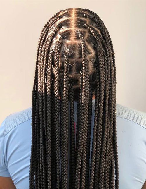 Back view of long box braids with clean square parts and neat, uniform braids falling down the back.