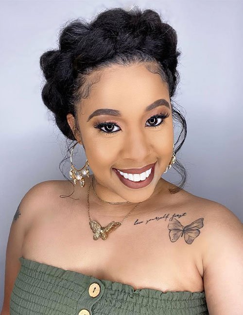 Braided halo updo with a crown-like braid wrapped around the head and soft face tendrils.