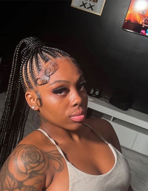 High braided ponytail with feed-in cornrows and long braids, finished with swooped baby hairs.