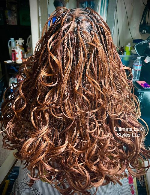Braids with curls hairstyle featuring loose defined curls and small braided sections