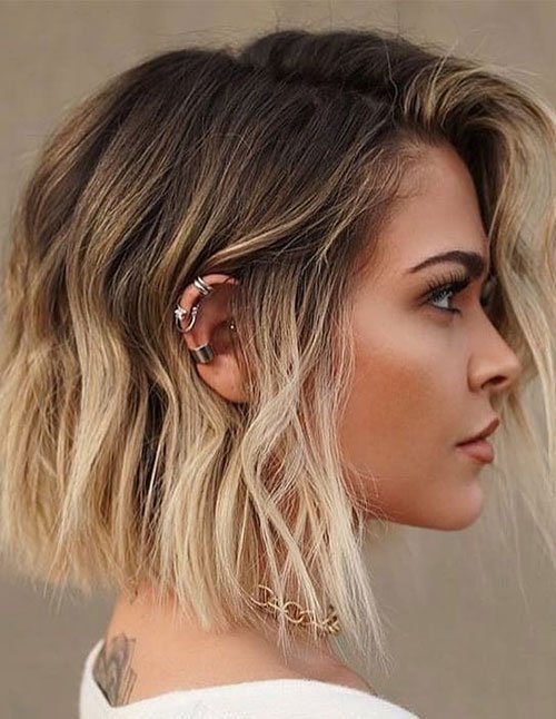 Side-profile choppy bob hairstyle with tousled waves and blonde balayage highlights