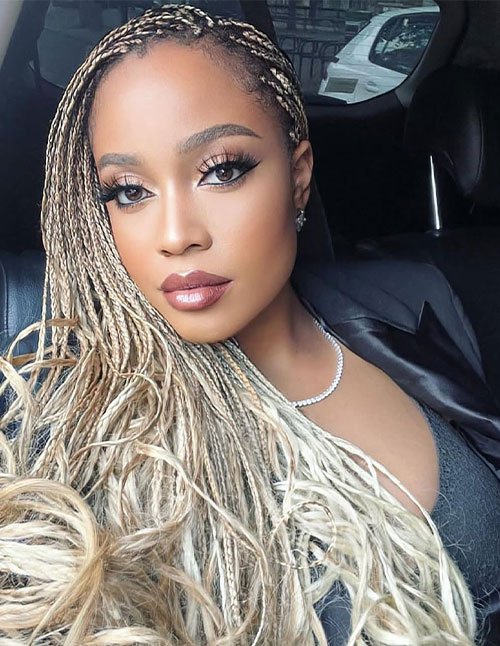Classic golden braids style with a side part, featuring long blonde box braids with a dark-to-light blend and a smooth, sleek finish.