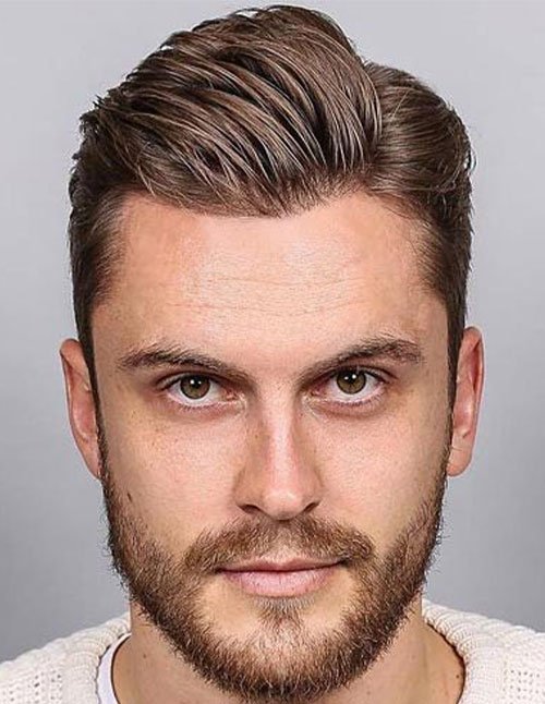 Man with a classic comb over hairstyle, featuring neatly parted hair styled to one side with a clean finish.