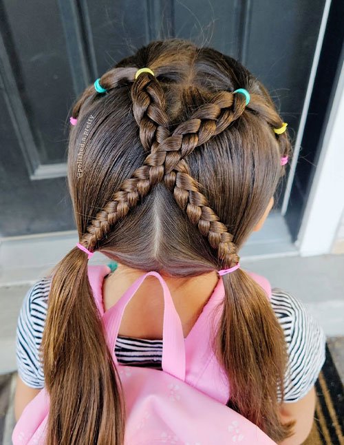 Criss-cross Dutch braids leading into low pigtails with colorful elastics