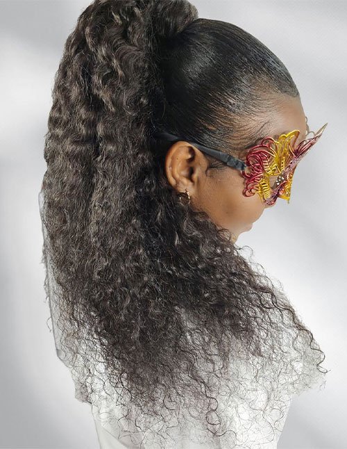 Girl wearing a sleek high curly ponytail with tight, defined curls cascading down the back.