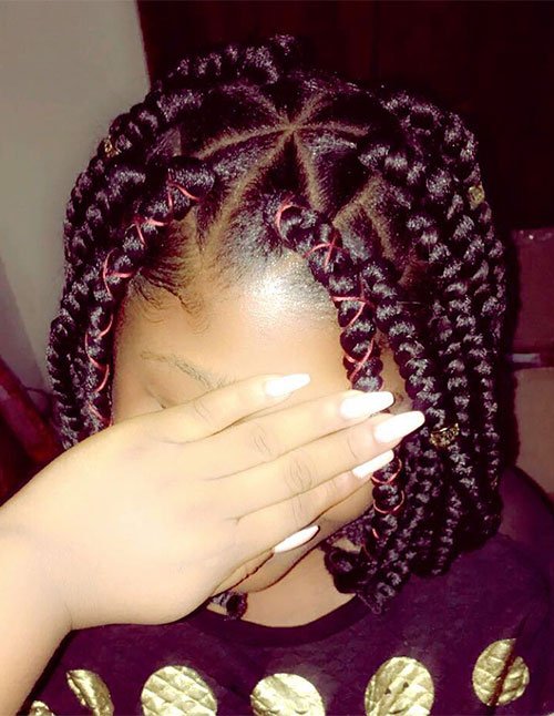 Short box braids bob with chunky twists, star-shaped parting, and red thread accents woven through the braids.