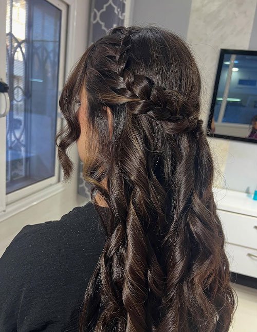 Cute Quick Hairstyle with a crown braid half-up and long, curled hair left down.