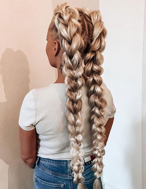 Dragon braid hairstyle with two thick, oversized braids on long blonde hair
