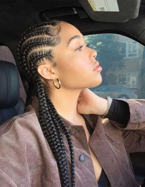 Sleek straight-back cornrow braids styled into two long plaits, neat scalp parts, side profile.