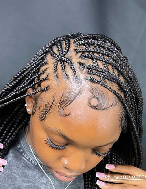Feed-in Fulani braids with detailed scalp pattern and long braids, finished with styled swoop baby hairs.