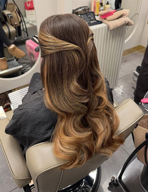 Half-up formal hairstyle with soft waves and blended highlights