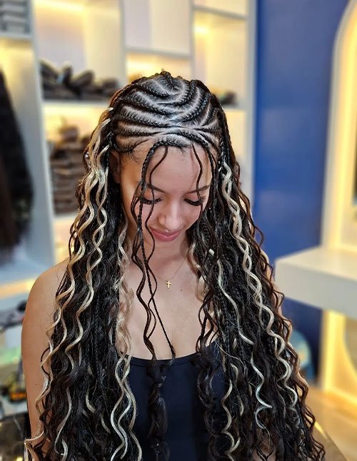 Fulani braids with gold cuffs featuring detailed scalp braids and long loose curls with blonde highlights.