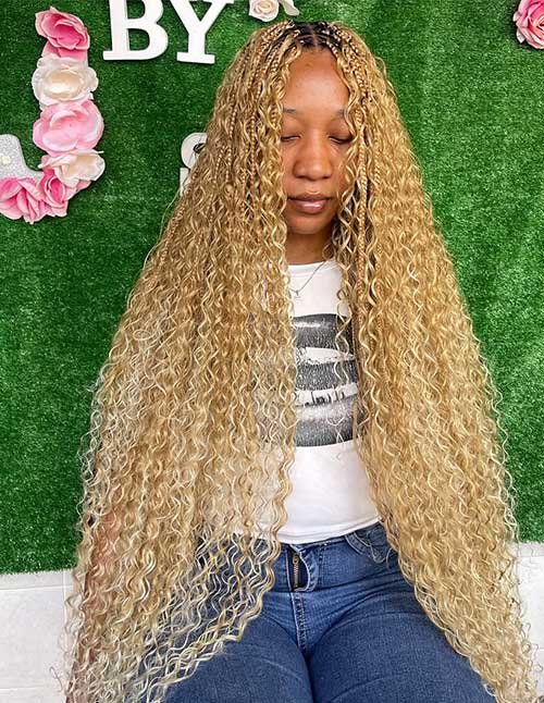 Goddess braids with curly blonde lengths, featuring small braids at the crown and long defined curls cascading past the waist.