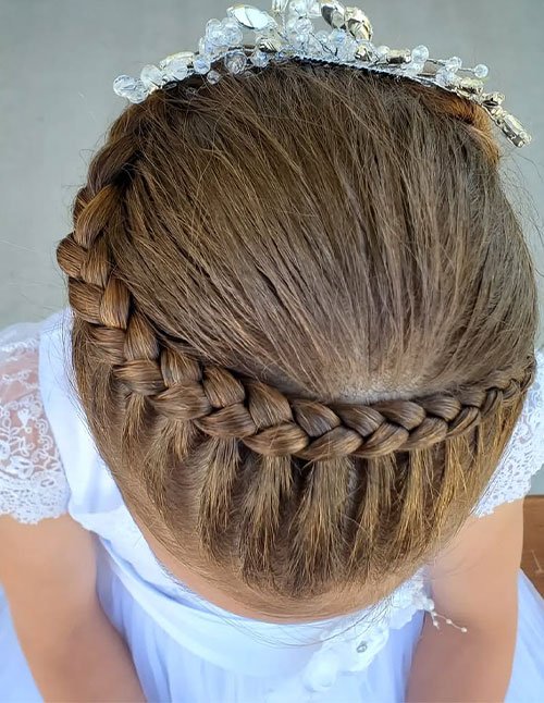 Top view of a hair braid crown styled with a smooth, wrapped braid encircling the head and finished with a delicate crystal tiara.