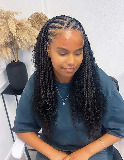 Half cornrows half knotless braids hairstyle with neat scalp braids in front and long curly knotless braids at the back.