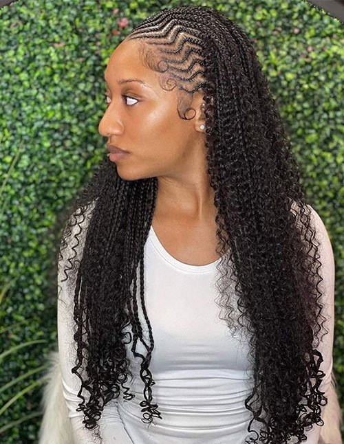 Intricate cornrow braids with long voluminous curls and styled baby hairs