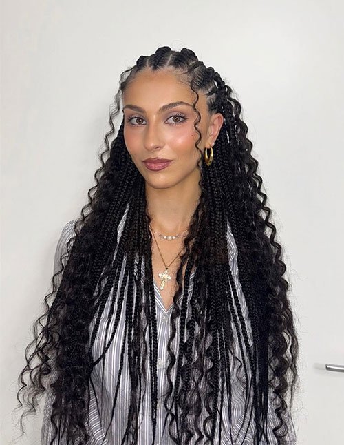 Knotless boho braids with loose curls and face-framing tendrils.